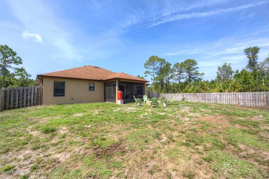 249 Franzing Street Palm Bay, FL 32908 - Photo 19 of 20 a front view of a house with a yard