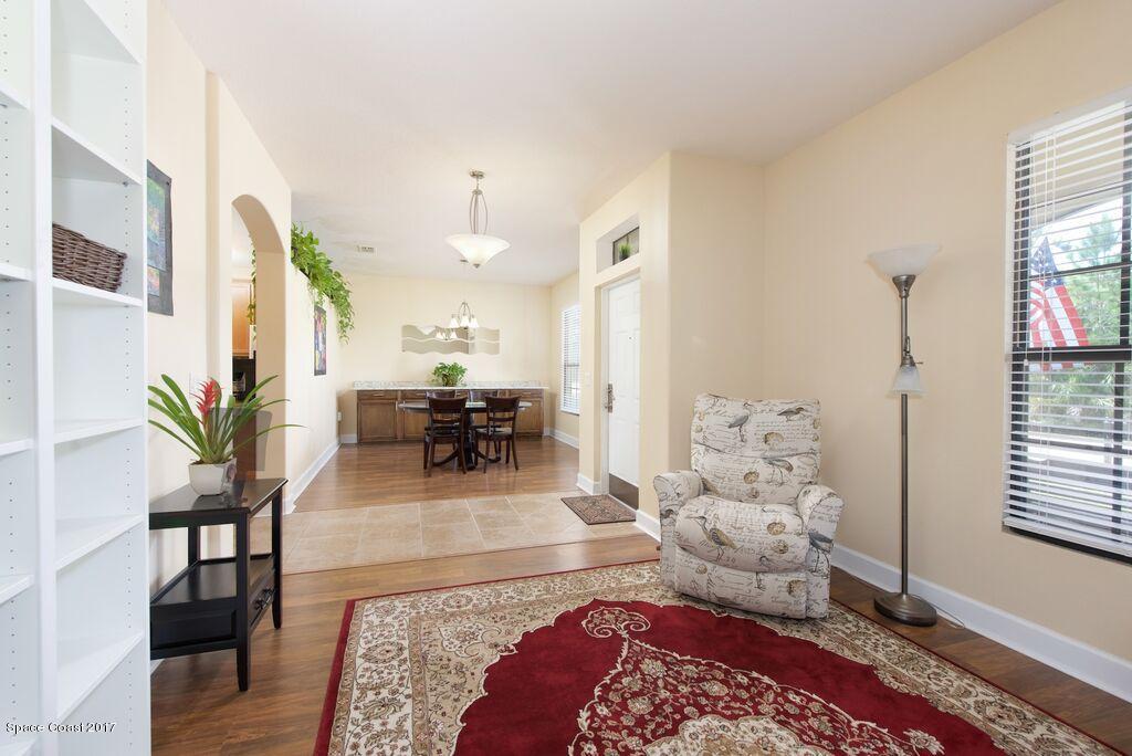 249 Franzing Street Palm Bay, FL 32908 - Photo 3 of 20 a living room with furniture and wooden floor