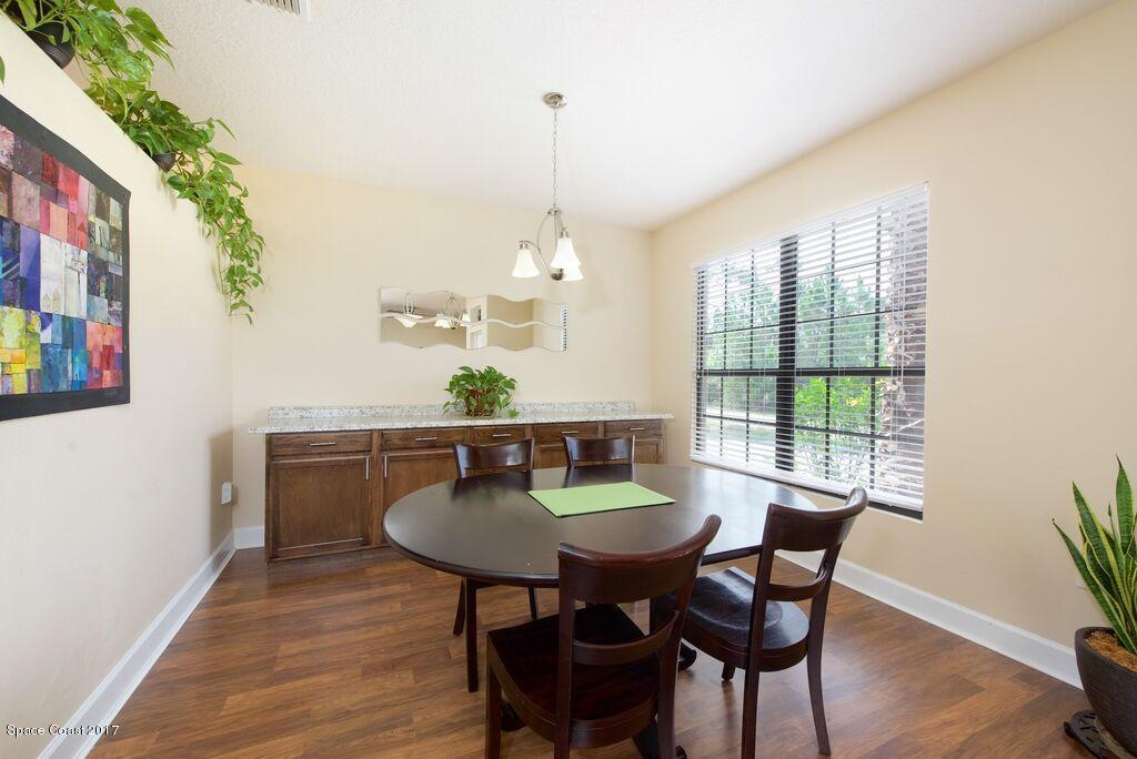 249 Franzing Street Palm Bay, FL 32908 - Photo 4 of 20 a view of a dining room with furniture window and wooden floor