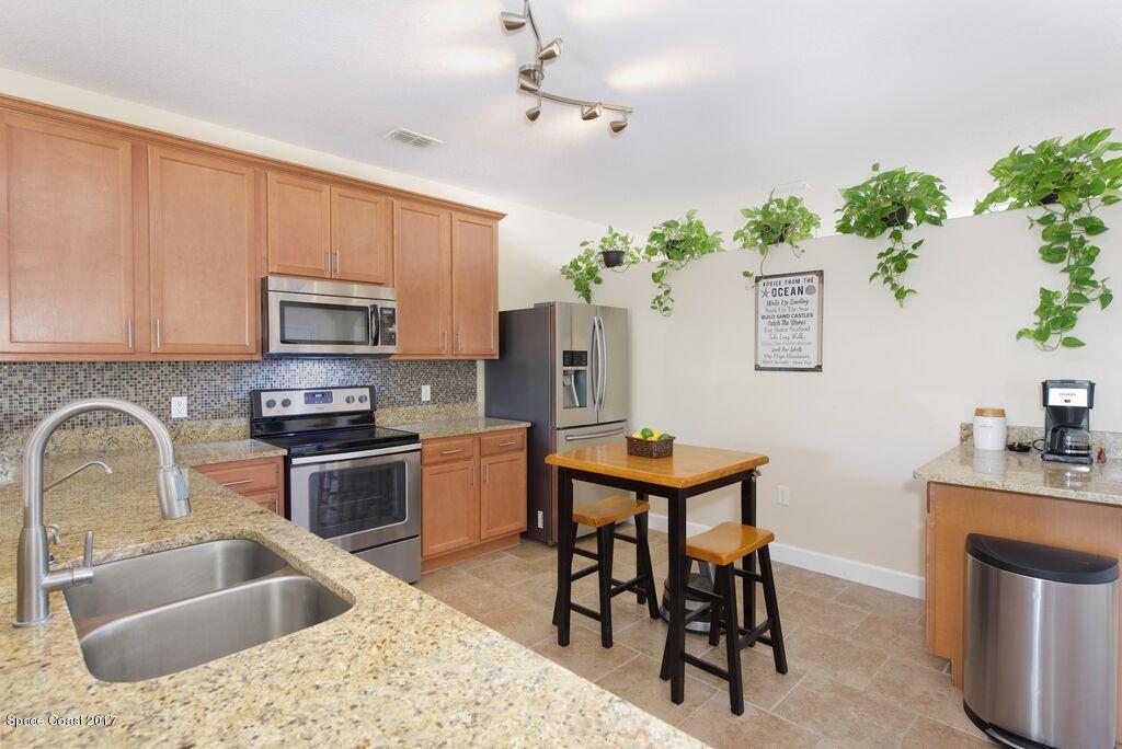 249 Franzing Street Palm Bay, FL 32908 - Photo 7 of 20 a kitchen with a table chairs sink and microwave