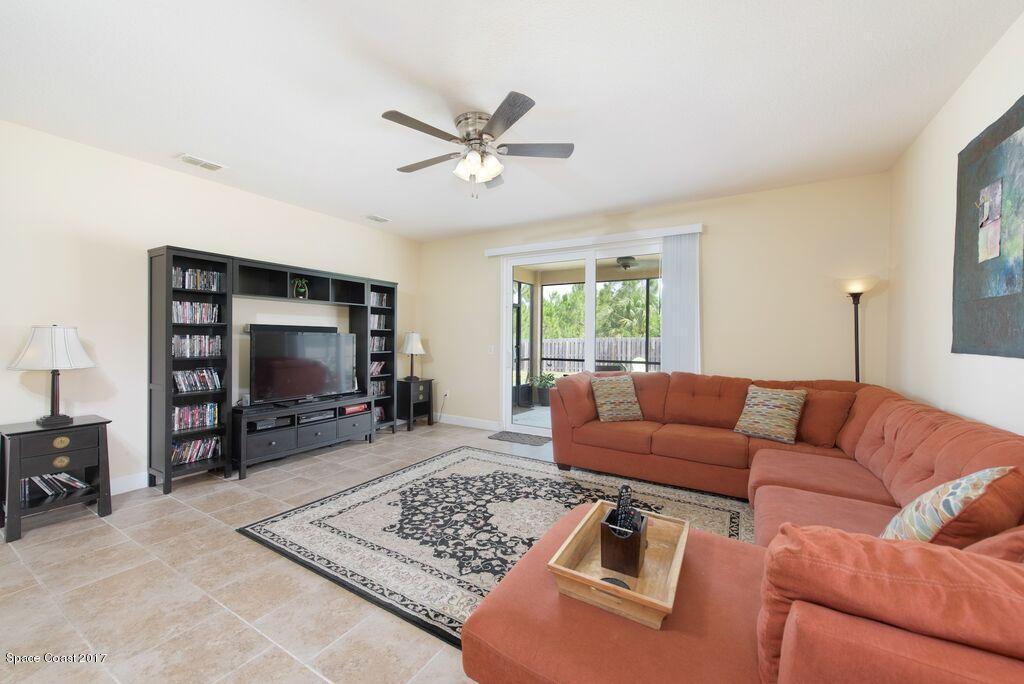 249 Franzing Street Palm Bay, FL 32908 - Photo 8 of 20 a living room with furniture and a flat screen tv