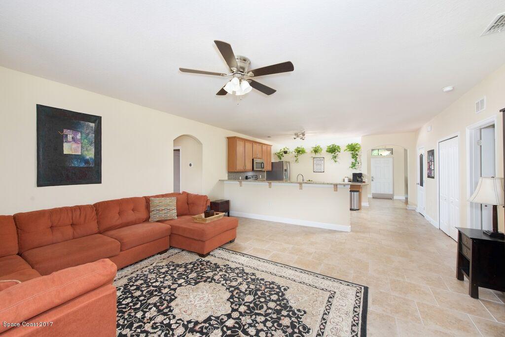 249 Franzing Street Palm Bay, FL 32908 - Photo 20 of 20 a living room with furniture and a chandelier