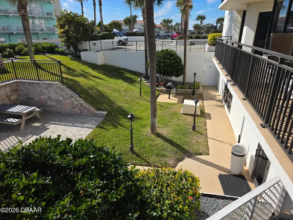 a view of a swimming pool with a patio and garden