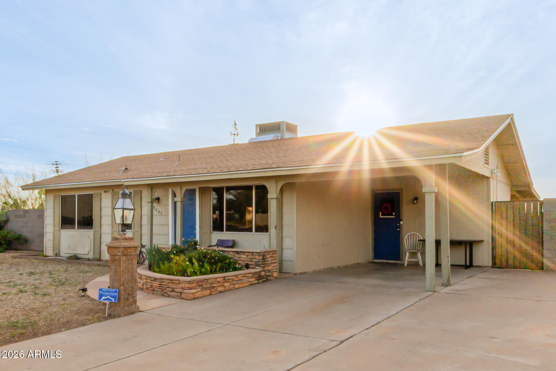 9403 East Cisco Road Mesa, AZ 85207 - Photo 2 of 20 a view of a white house with potted plants and a table and chairs