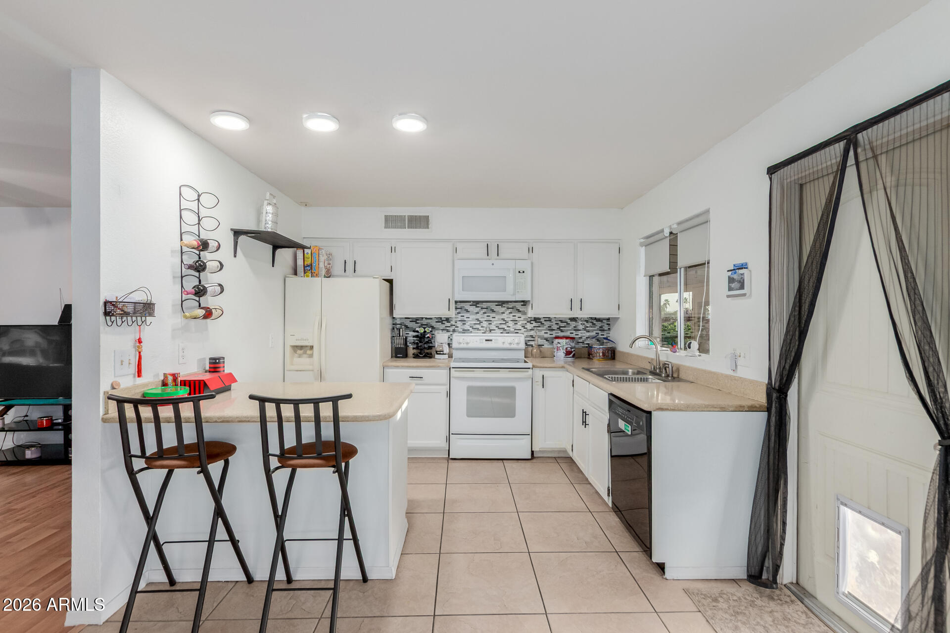 9403 East Cisco Road Mesa, AZ 85207 - Photo 6 of 20 a kitchen with white cabinets and stainless steel appliances