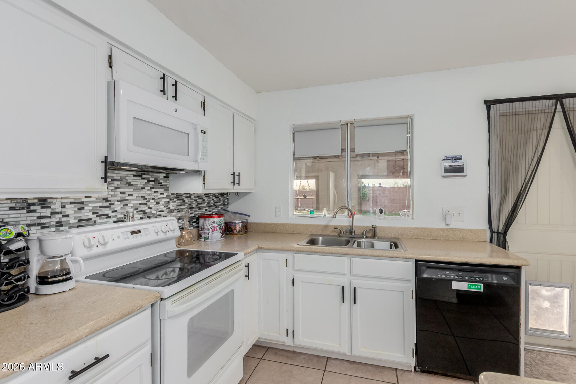 9403 East Cisco Road Mesa, AZ 85207 - Photo 9 of 20 a kitchen with white cabinets sink and white appliances