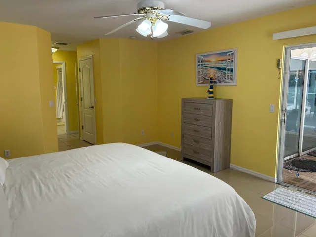 a bedroom with a bed and a mirror