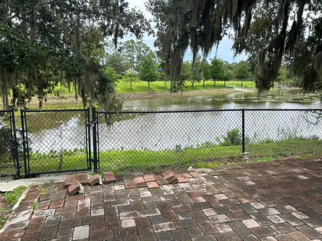 a view of a lake with a yard and plants