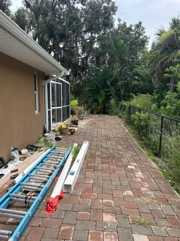 a view of a house with a garden and a car parked
