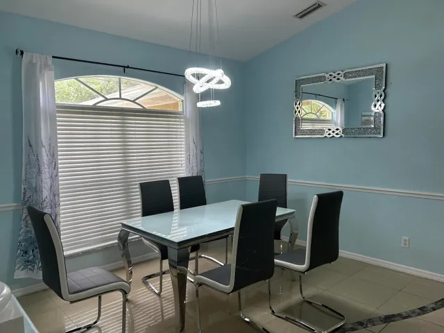 a view of a dining room with furniture and a window
