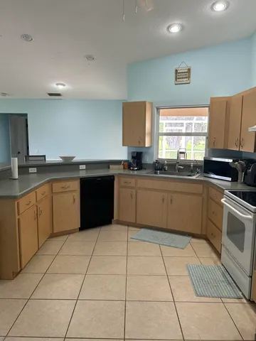 a kitchen with a sink a stove a microwave and cabinets