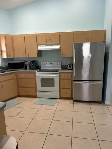a kitchen with cabinets and steel stainless steel appliances