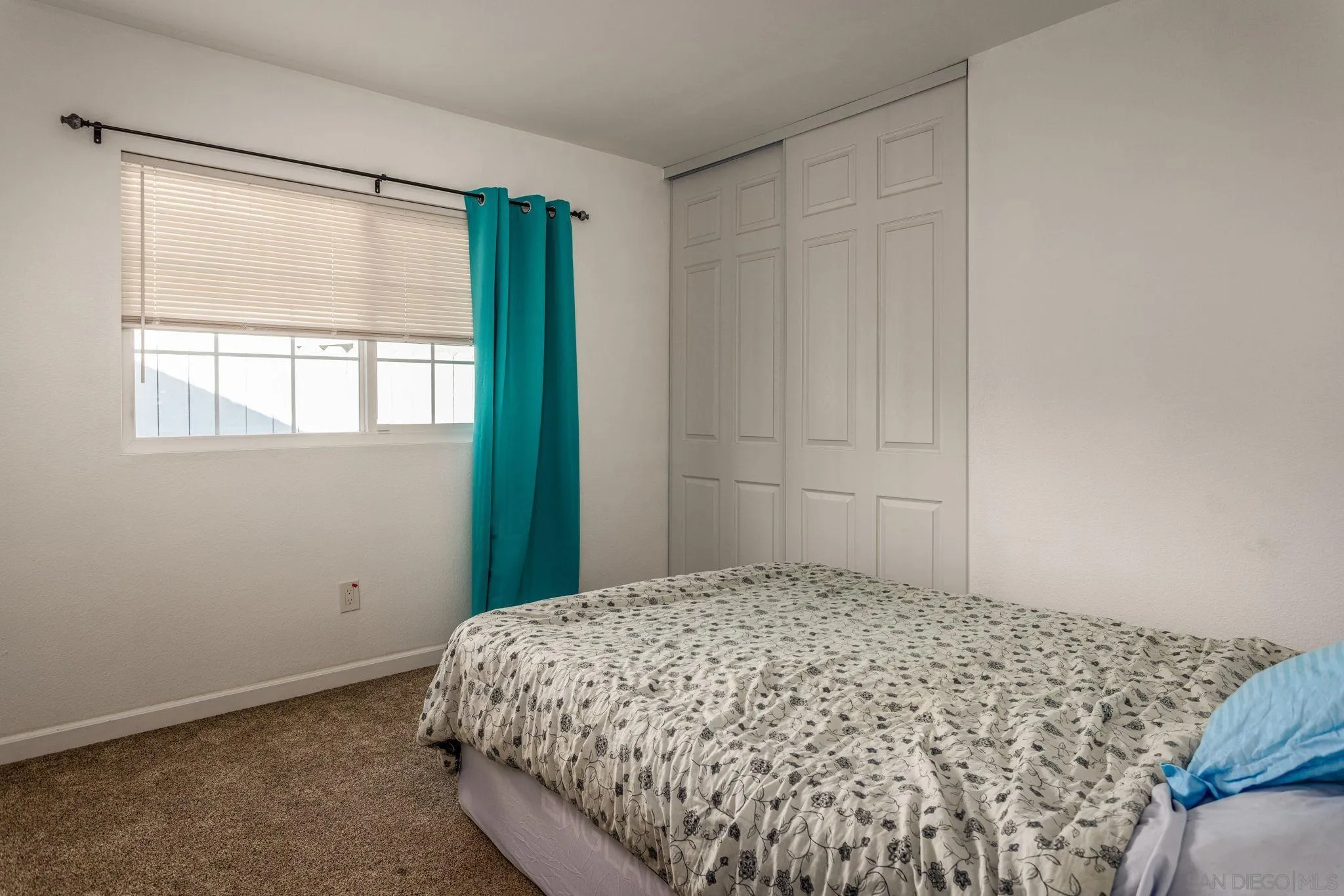 532 Kempton Street Spring Valley, CA 91977 - Photo 14 of 30 a bedroom with a bed and a window