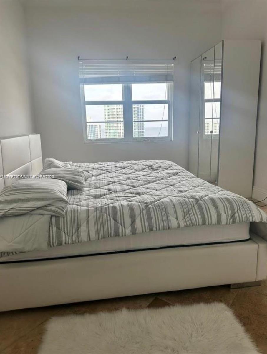 6770 Indian Creek Drive, Unit TSB Miami Beach, FL 33141 - Photo 6 of 12 a bedroom with a bed next to a window