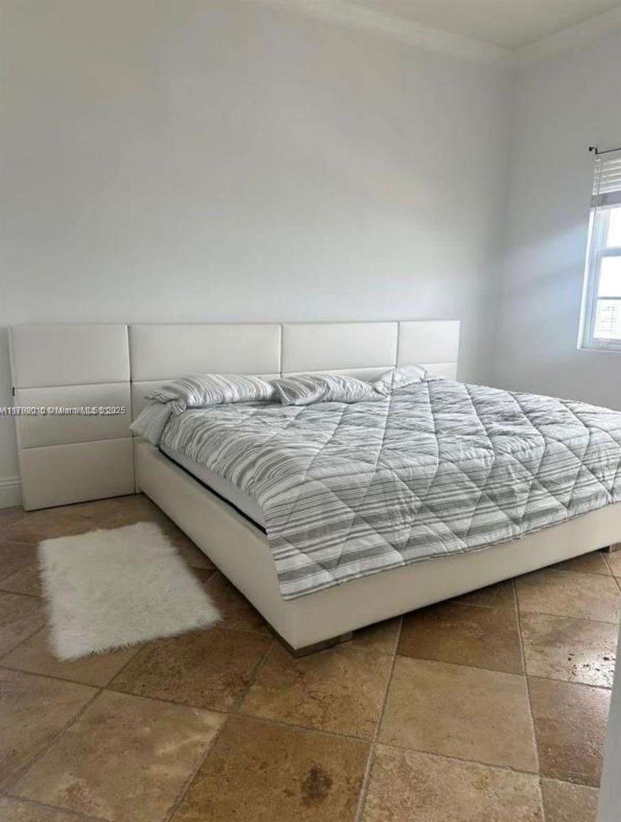 6770 Indian Creek Drive, Unit TSB Miami Beach, FL 33141 - Photo 7 of 12 a bedroom with a bed and a lamp on the dresser