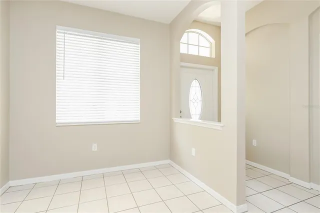 an empty room that has a window in it