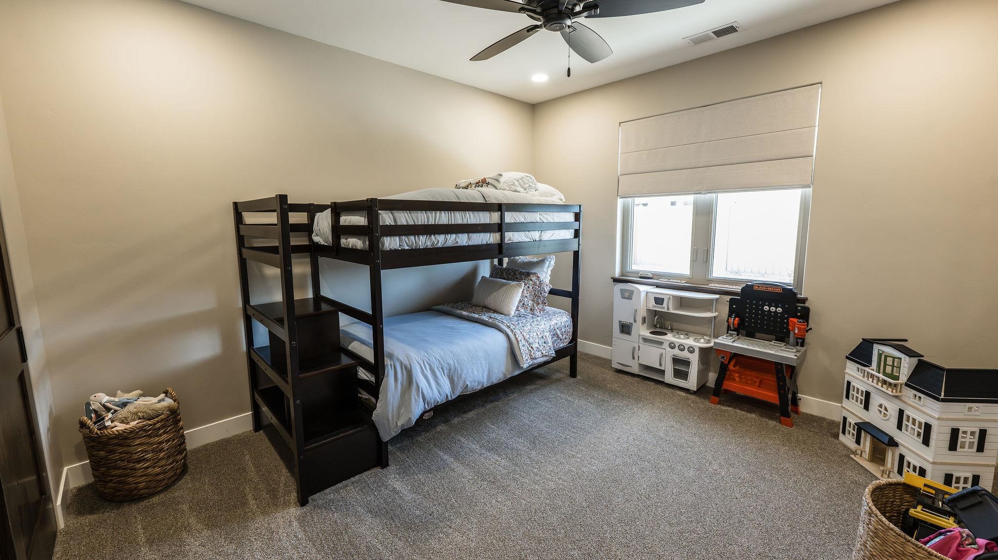 2639 Emerald Ridge Lane Grand Junction, CO 81506 - Photo 29 of 42 a bedroom with a bed and a chandelier