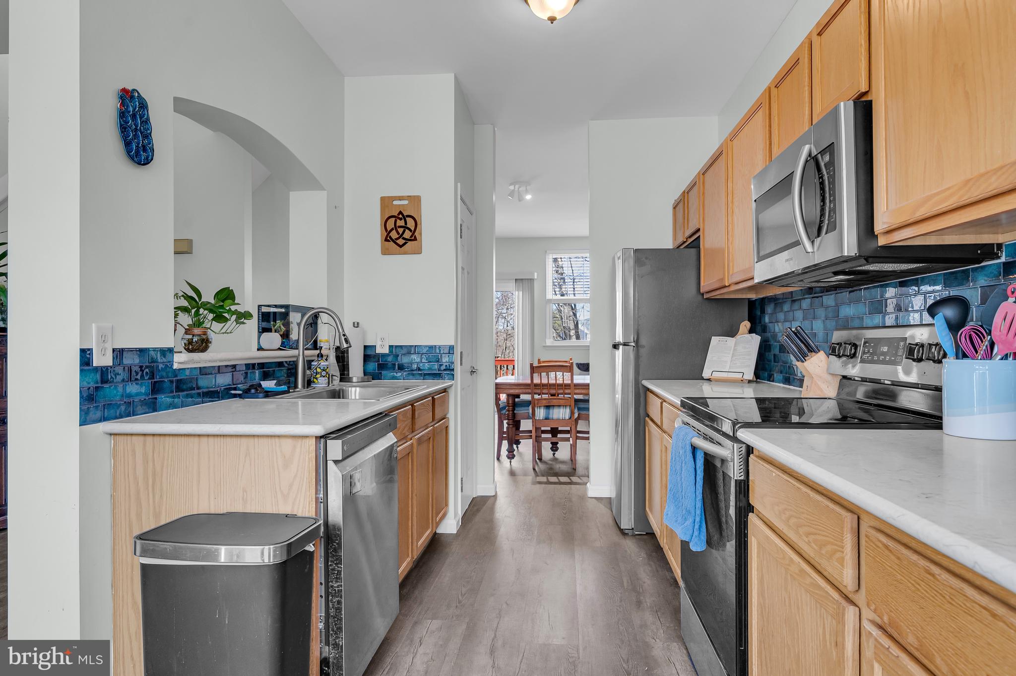 43 Wicklow Road Bear, DE 19701 - Photo 17 of 37 a kitchen with stainless steel appliances granite countertop a sink stove and refrigerator