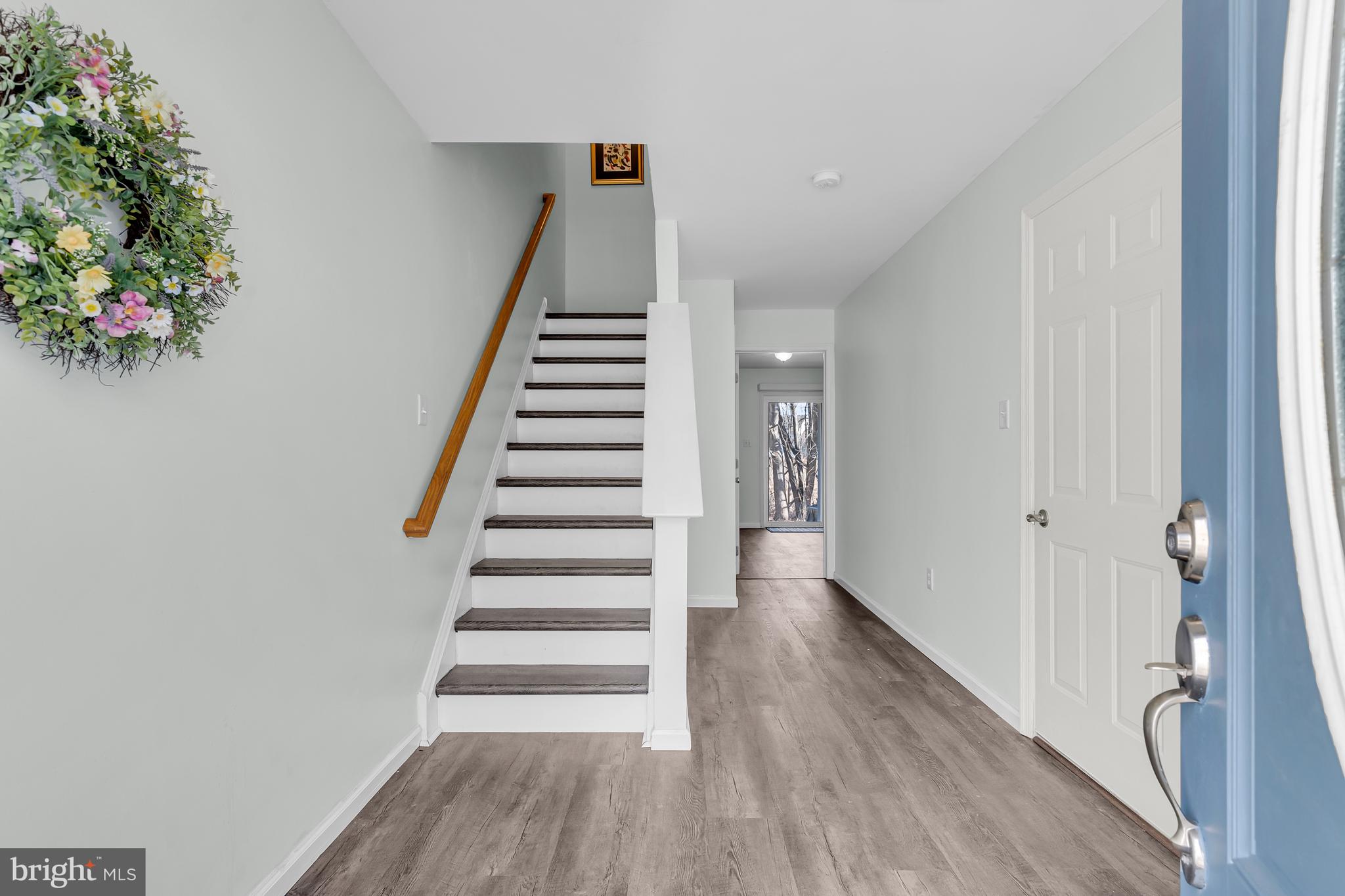 43 Wicklow Road Bear, DE 19701 - Photo 5 of 37 a view of entryway with stairs and wooden floor