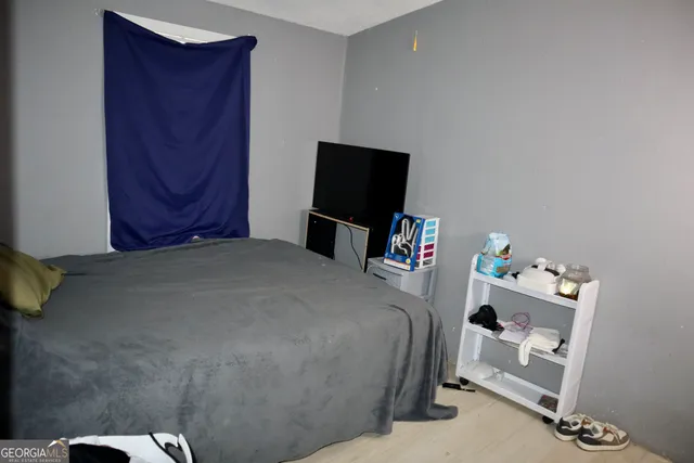 a bedroom with a bed and a flat screen tv