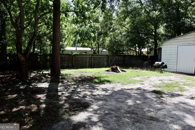 a view of a backyard with a tree