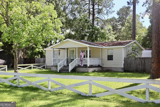 a view of a house with swimming pool and yard