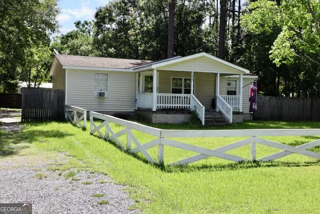 a front view of house with yard and trees