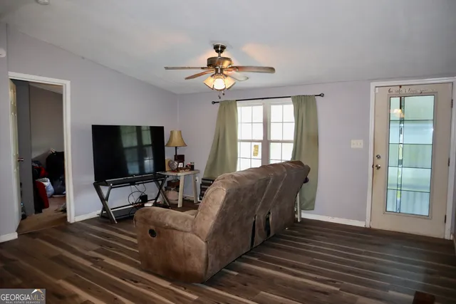 a living room with furniture and a flat screen tv