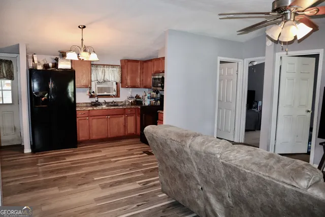 a kitchen with stainless steel appliances granite countertop a refrigerator a stove and a refrigerator