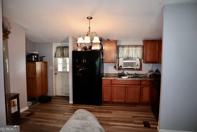 a kitchen with stainless steel appliances granite countertop a refrigerator and a stove