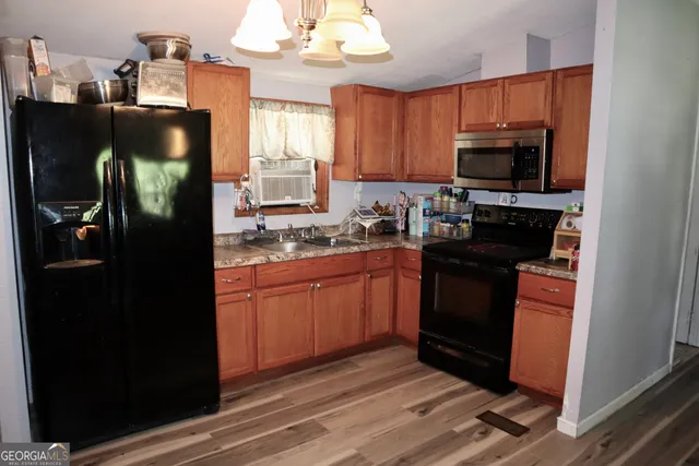 a kitchen with stainless steel appliances granite countertop a refrigerator stove and microwave