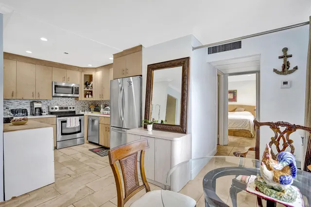 a kitchen with stainless steel appliances a refrigerator and a stove top oven