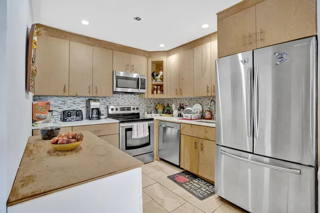a kitchen with a refrigerator sink and microwave