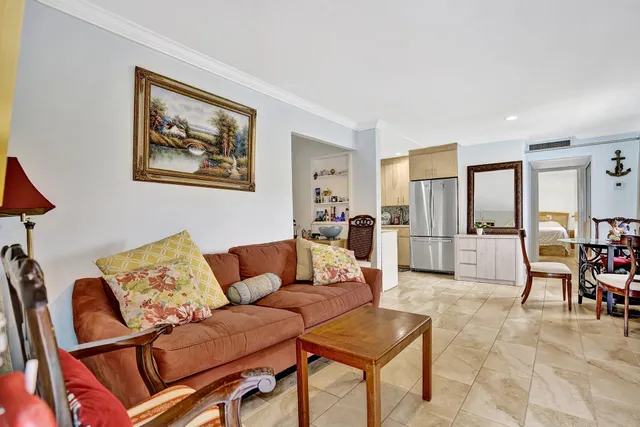a living room with furniture and a kitchen view