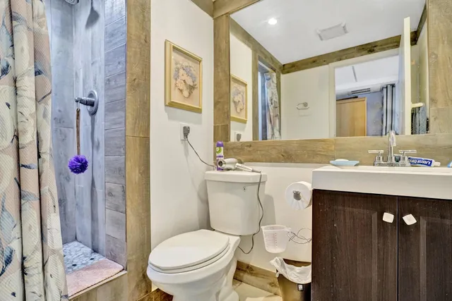 a bathroom with a sink toilet and shower