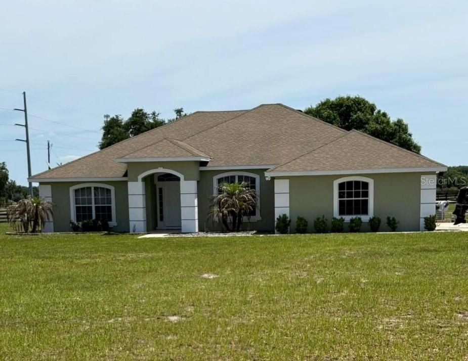 41430 Roger Giles Road Umatilla, FL 32784 - Photo 1 of 27 a house with garden in front of it