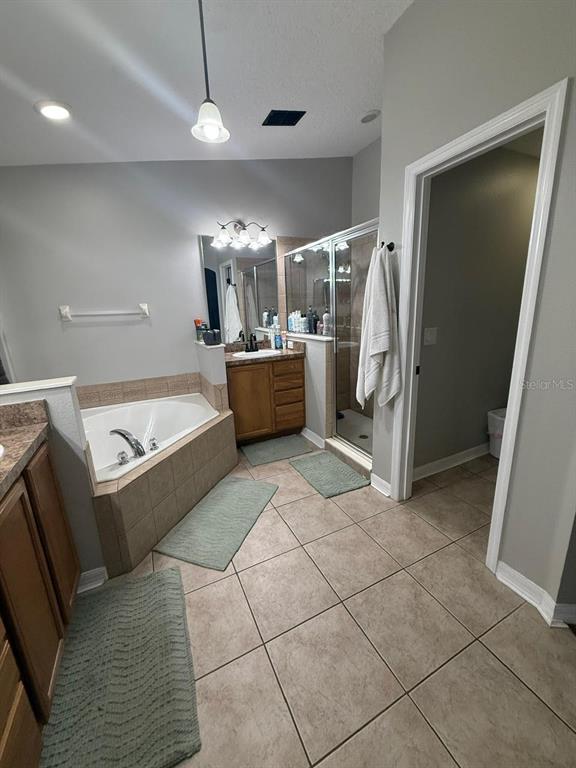 41430 Roger Giles Road Umatilla, FL 32784 - Photo 12 of 27 a large room with a couch and a ceiling fan
