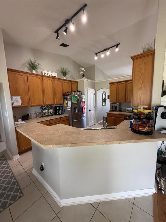 41430 Roger Giles Road Umatilla, FL 32784 - Photo 15 of 27 a kitchen with stainless steel appliances granite countertop a sink a stove and a refrigerator