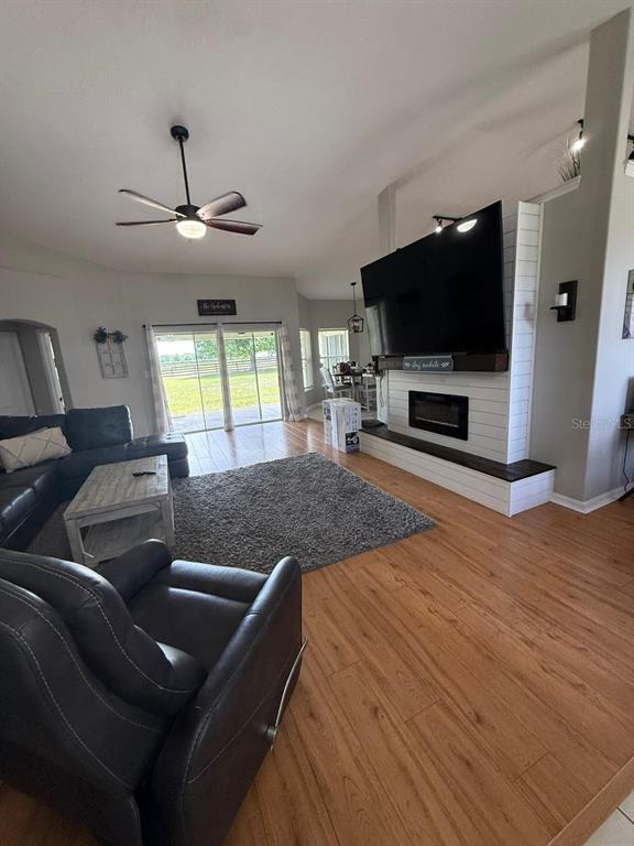 41430 Roger Giles Road Umatilla, FL 32784 - Photo 17 of 27 a living room with furniture and a flat screen tv