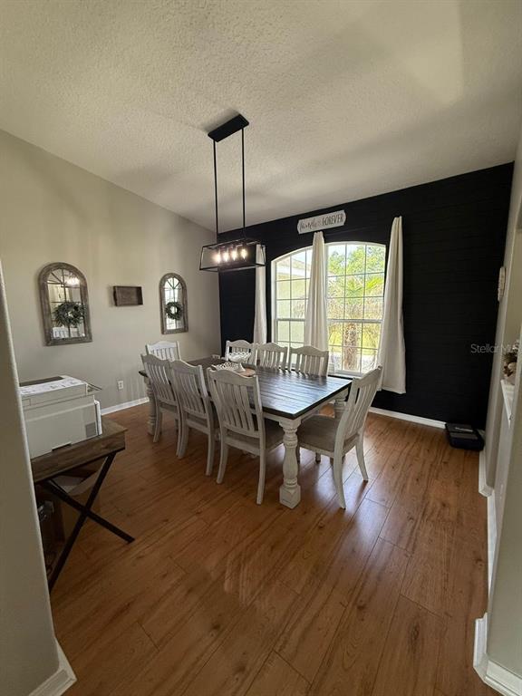 41430 Roger Giles Road Umatilla, FL 32784 - Photo 19 of 27 a view of a dining room with furniture window and wooden floor