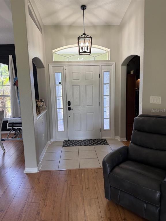 41430 Roger Giles Road Umatilla, FL 32784 - Photo 21 of 27 a living room with furniture and a chandelier
