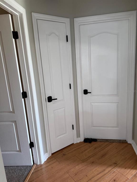 41430 Roger Giles Road Umatilla, FL 32784 - Photo 24 of 27 a view of a hallway with wooden floor
