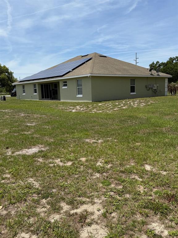 41430 Roger Giles Road Umatilla, FL 32784 - Photo 5 of 27 a front view of a house with a garden