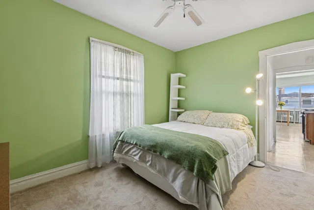 a bedroom with a bed and window