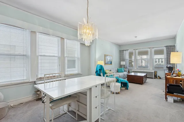 a dining room with furniture and window