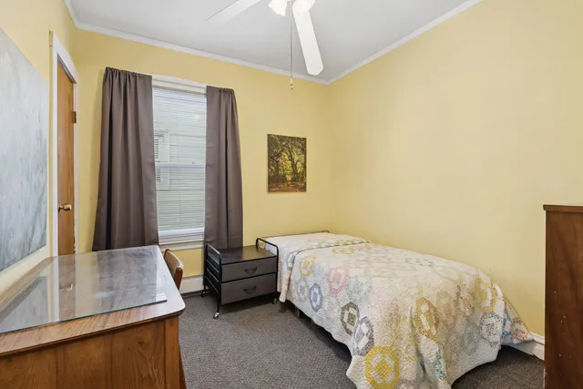 a bedroom with a bed and dresser