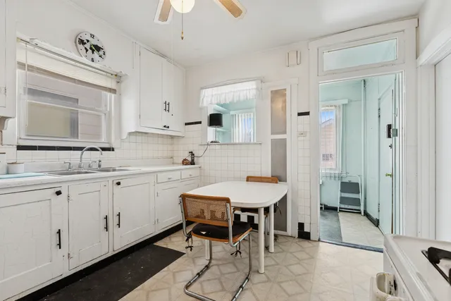 a spacious bathroom with a granite countertop sink a mirror and a shower