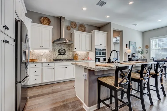 a kitchen with sink a granite counter top and stainless steel appliances