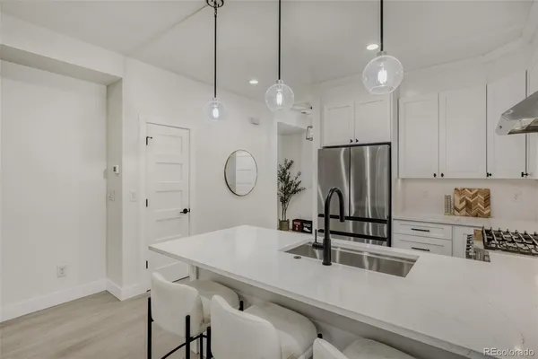 a kitchen with a table a sink and cabinets