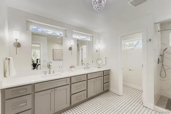 a spacious bathroom with a double vanity sink mirror and double
